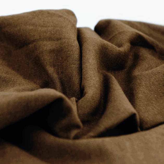 Linen Brown Fabric, made from 100% pure linen, is highly favored in the fashion industry, particularly during the spring and summer seasons. It offers excellent sun protection and is known for its ability to absorb moisture. Additionally, pure linen is a natural fabric with antibacterial properties. The process of creating linen involves carefully extracting and spinning the fibers into yarn, which is then woven to produce the linen fabric.